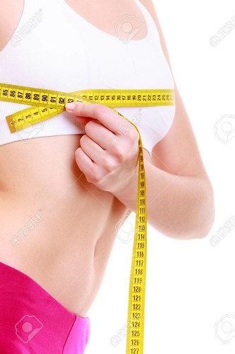 Fitness woman fit girl with measure tape measuring her bust