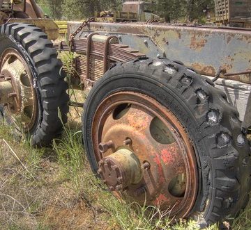 Dual-axle truck chassis with decaying old tires HDR
