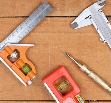 Woodworking Measuring Tools on the wooden table background