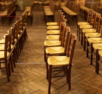 Group of wooden chairs with no people inside a church