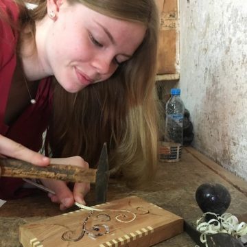 Corinna insets a design on her woodworking project