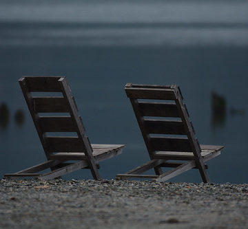 wooden chairs by the water