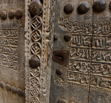 Woodwork on a mudhouse door in deserted Al Hamra.