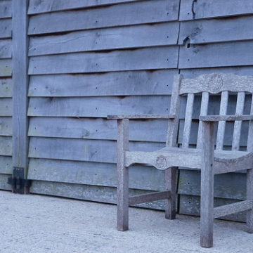 Wooden chair against wooden shed