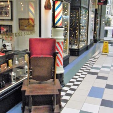 Manchester, Barton Arcade === men’s barbers shop showing old chair and sign