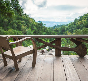Wooden armchair on terrace inside rainforest